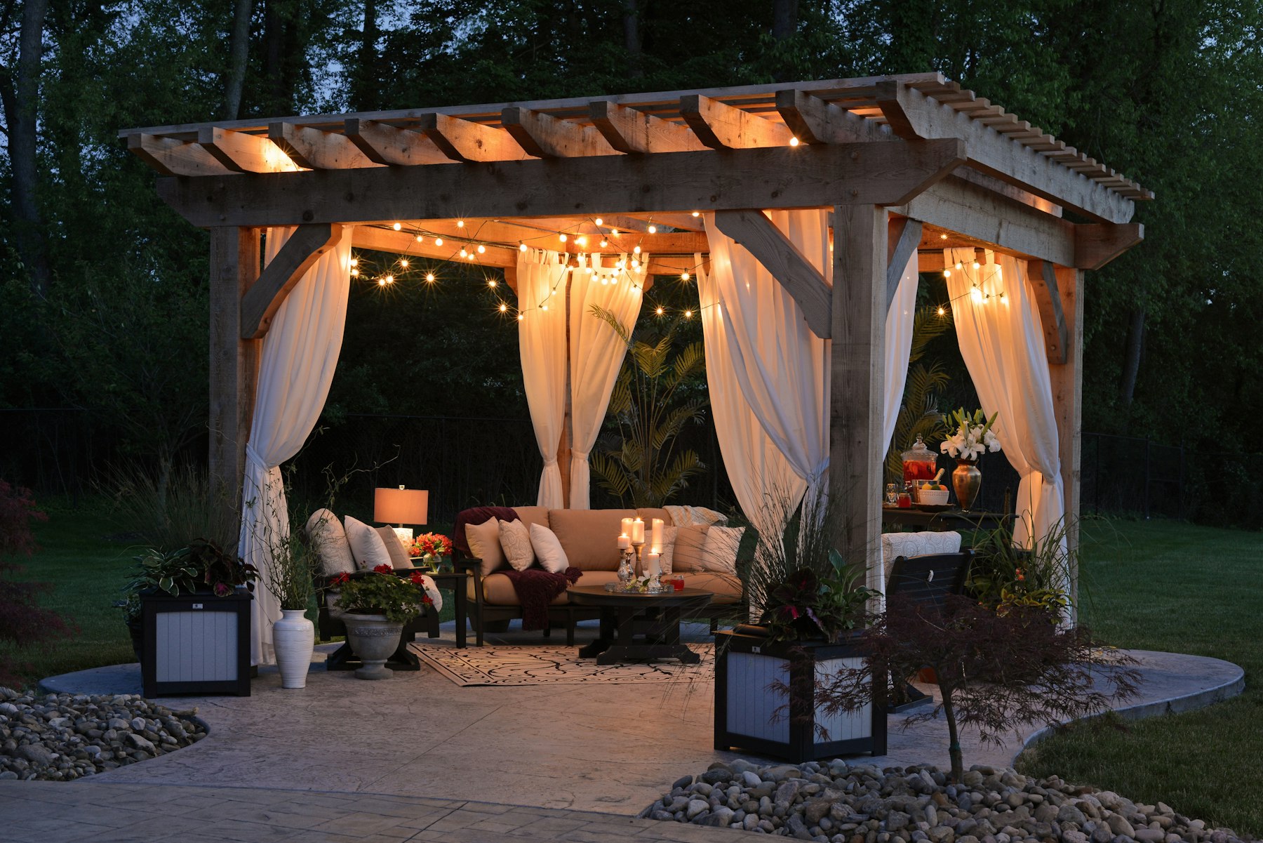 Backyard gazebo with warm string lights in the evening